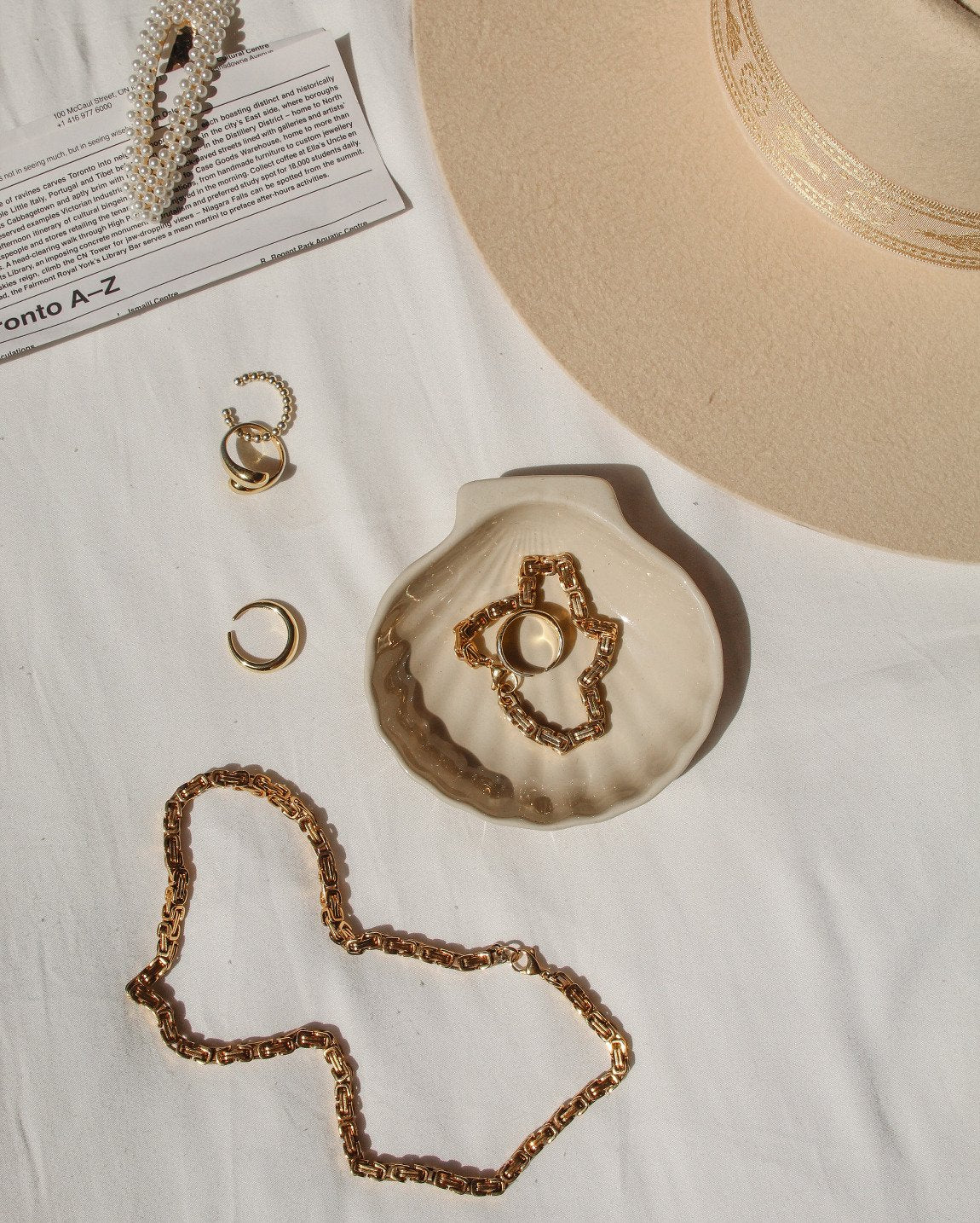 flatlay featuring the bare sea 18K gold plated sterling silver adriana necklace